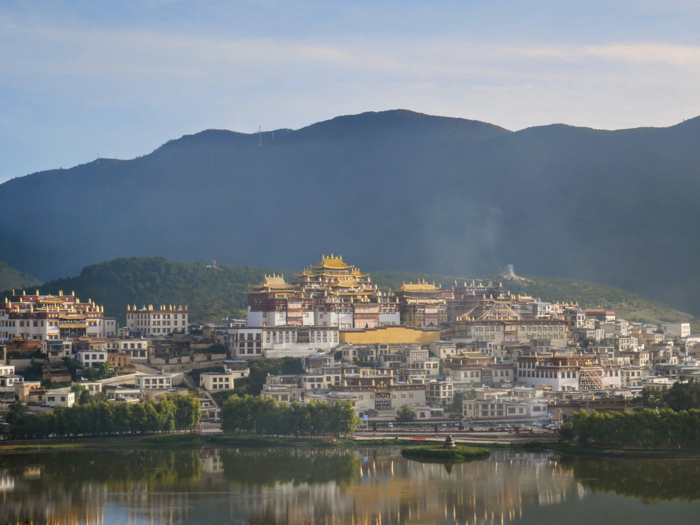 Songzanlin Monastery in Shangri-La, Yunnan, reflected beside the lake.