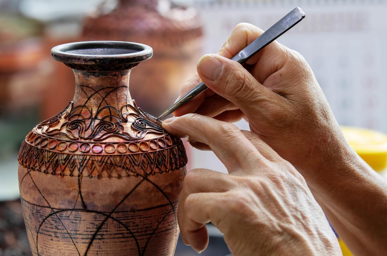 Chinese cloisonne-style craft used in a cultural workshop setting